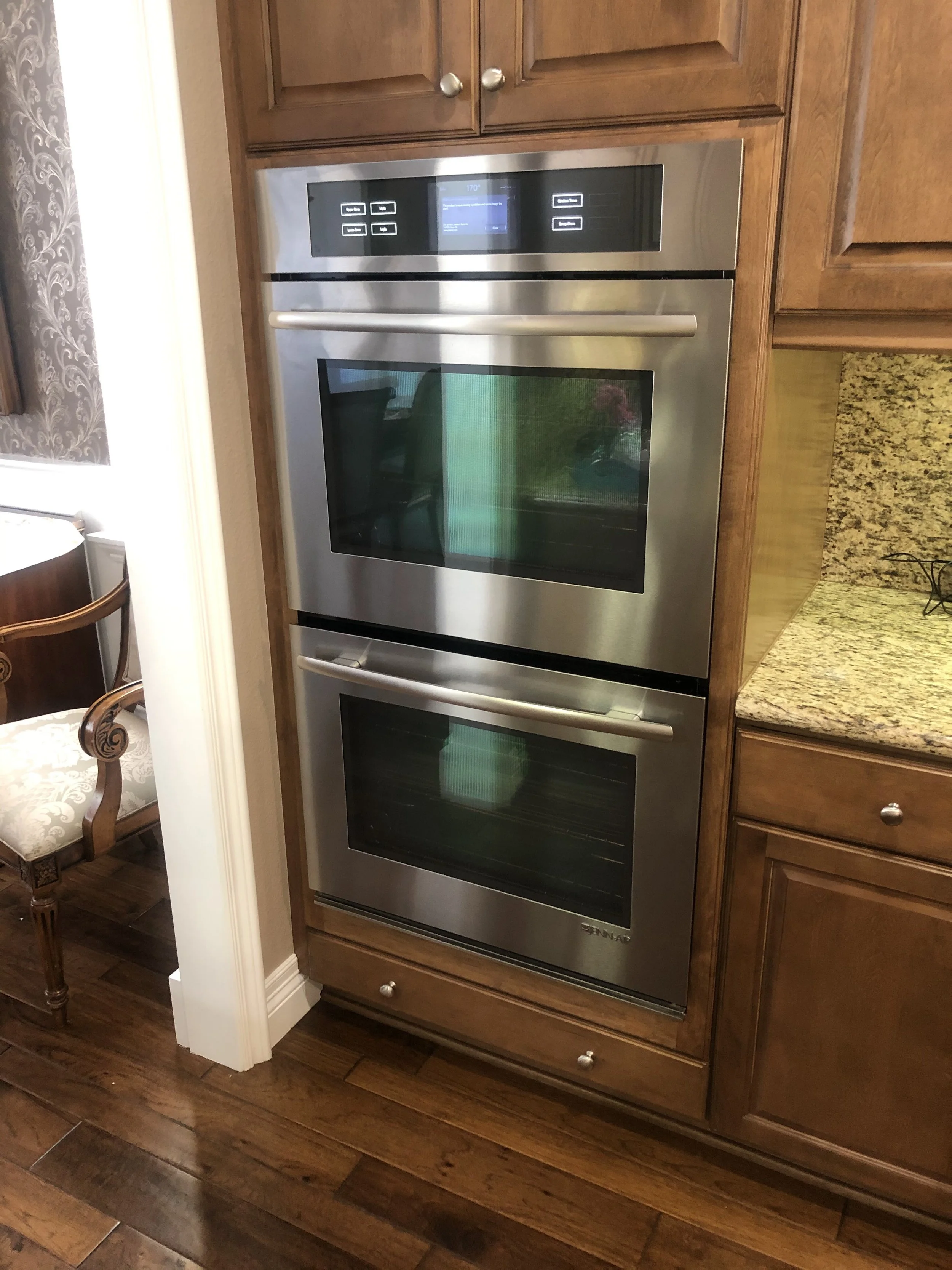 Stainless double wall oven in cabinetry during a Spokane appliance repair by SD Appliance