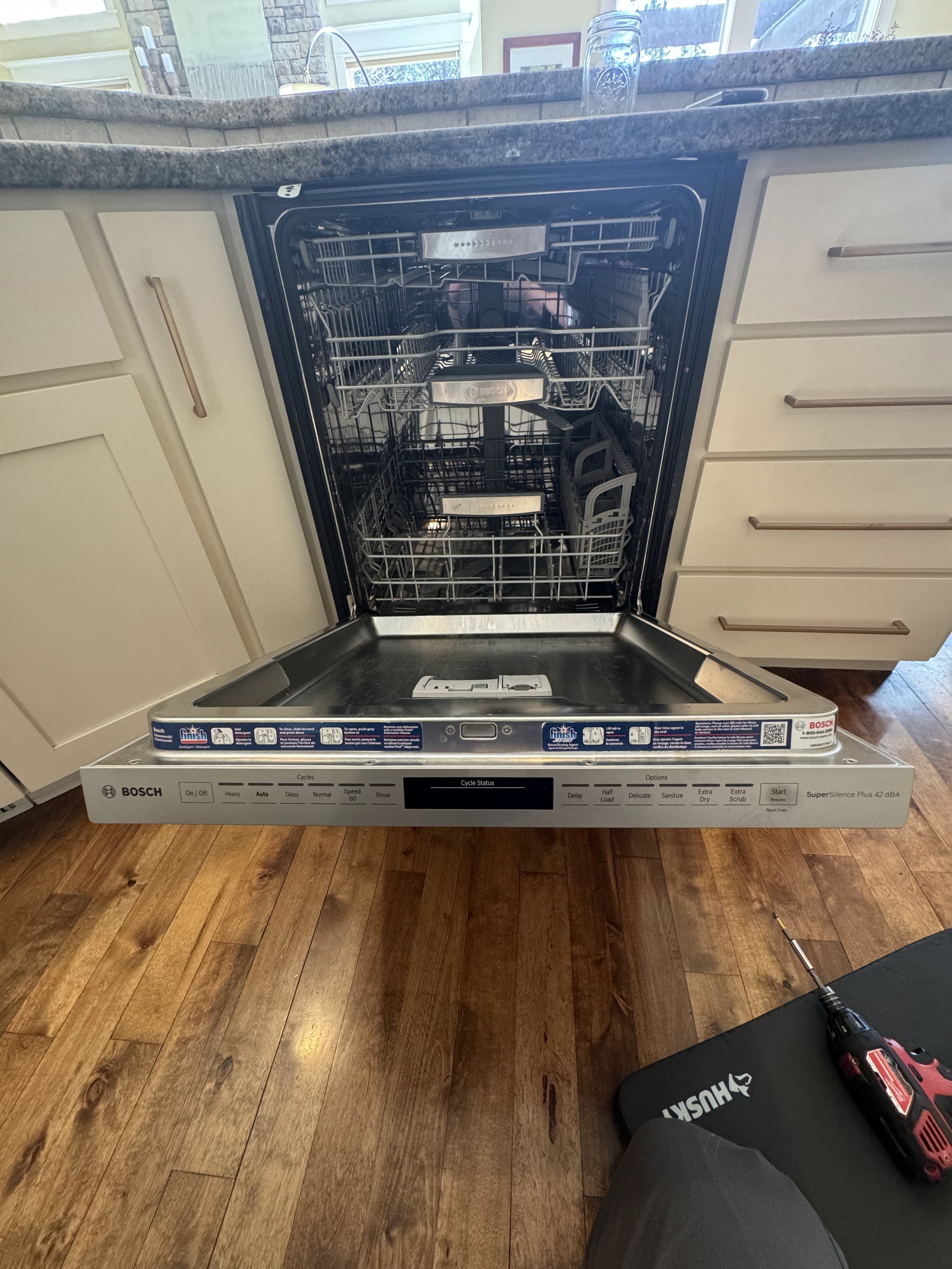Bosch dishwasher open, control panel visible