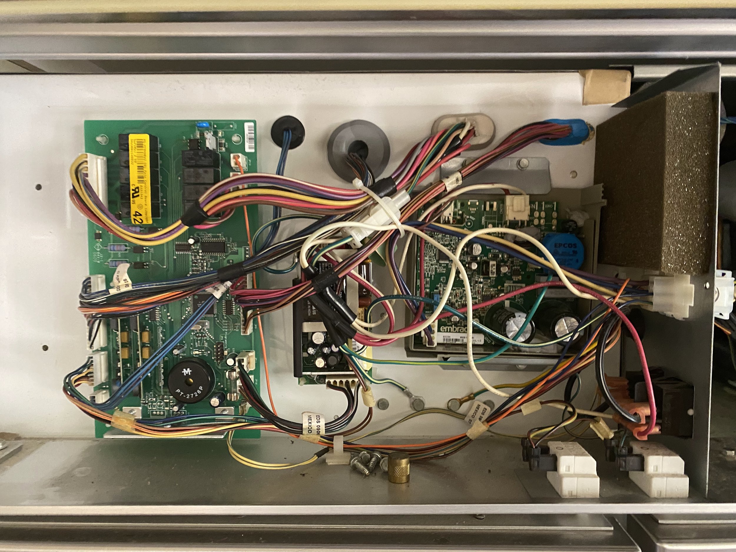 Control board with wiring during a microwave repair in Spokane