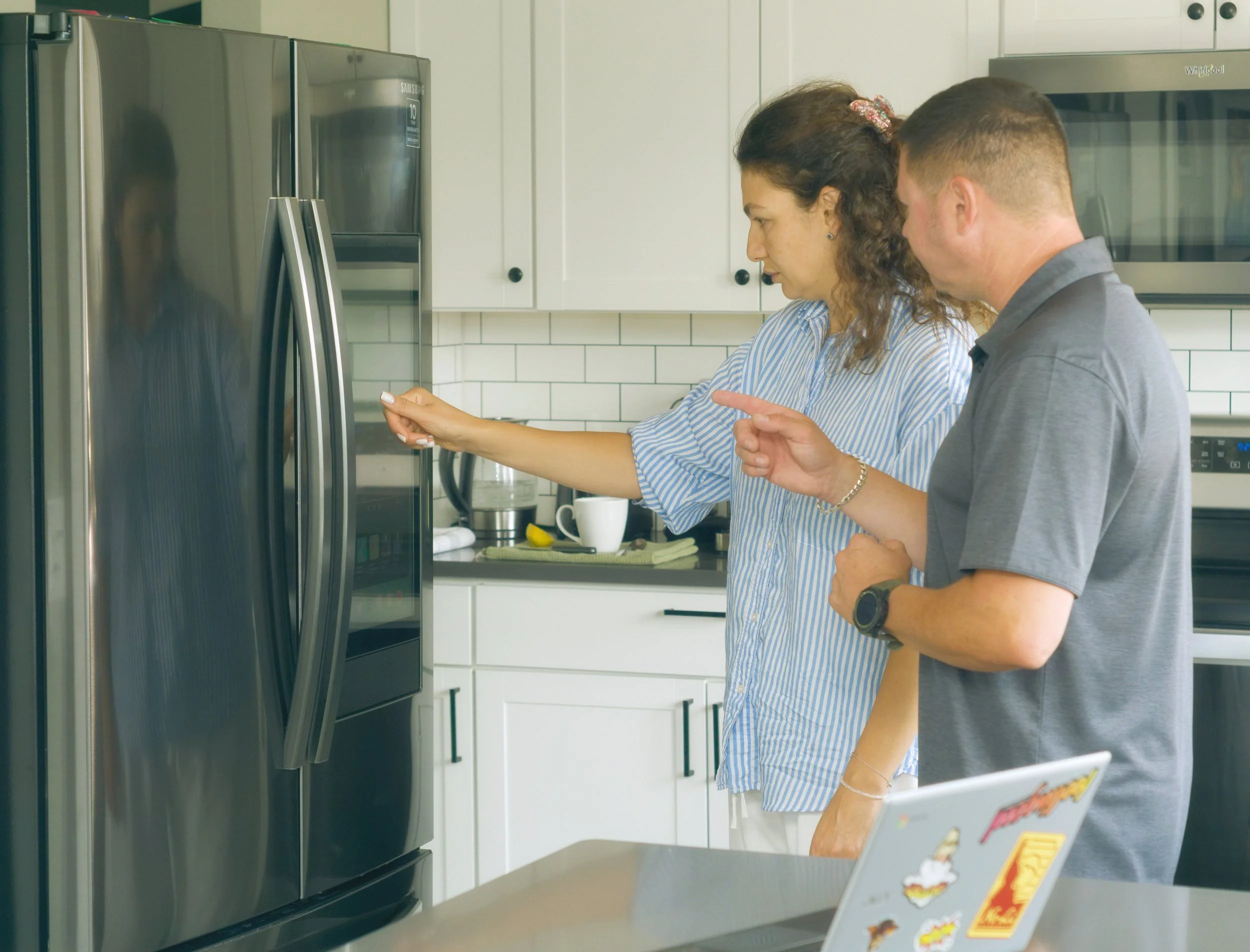 Sergei with a homeowner at the fridge during a Spokane appliance repair by SD Appliance