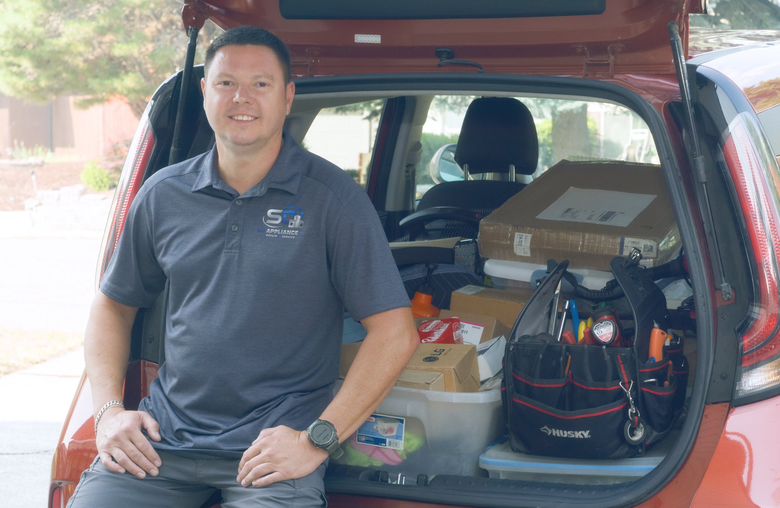 Sergei Dergunov at the van hatch, parts stocked, on a same-day appliance repair in Spokane