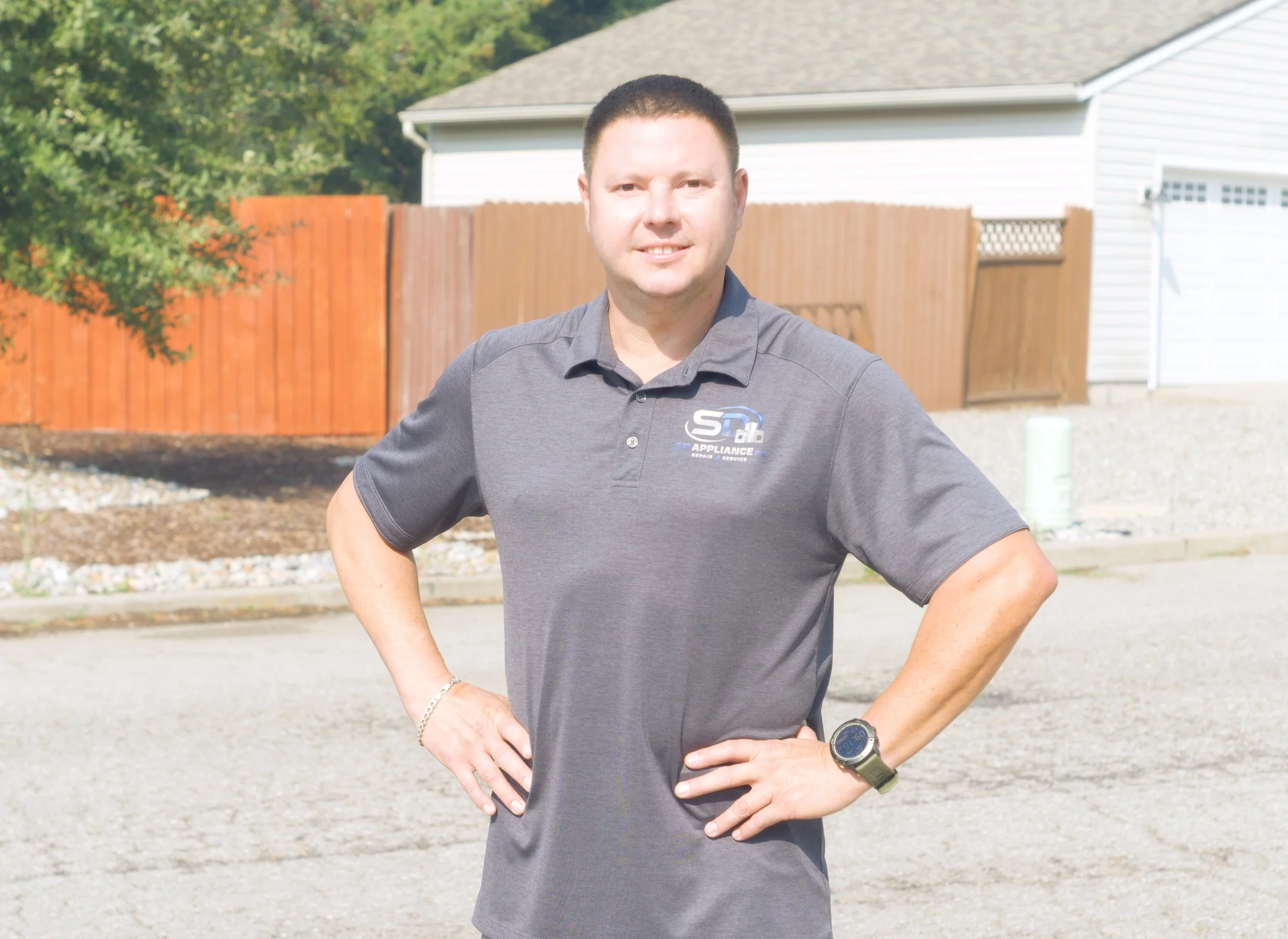 SD Appliance technician in a navy polo outdoors, ready for residential refrigerator repair in Post Falls homes