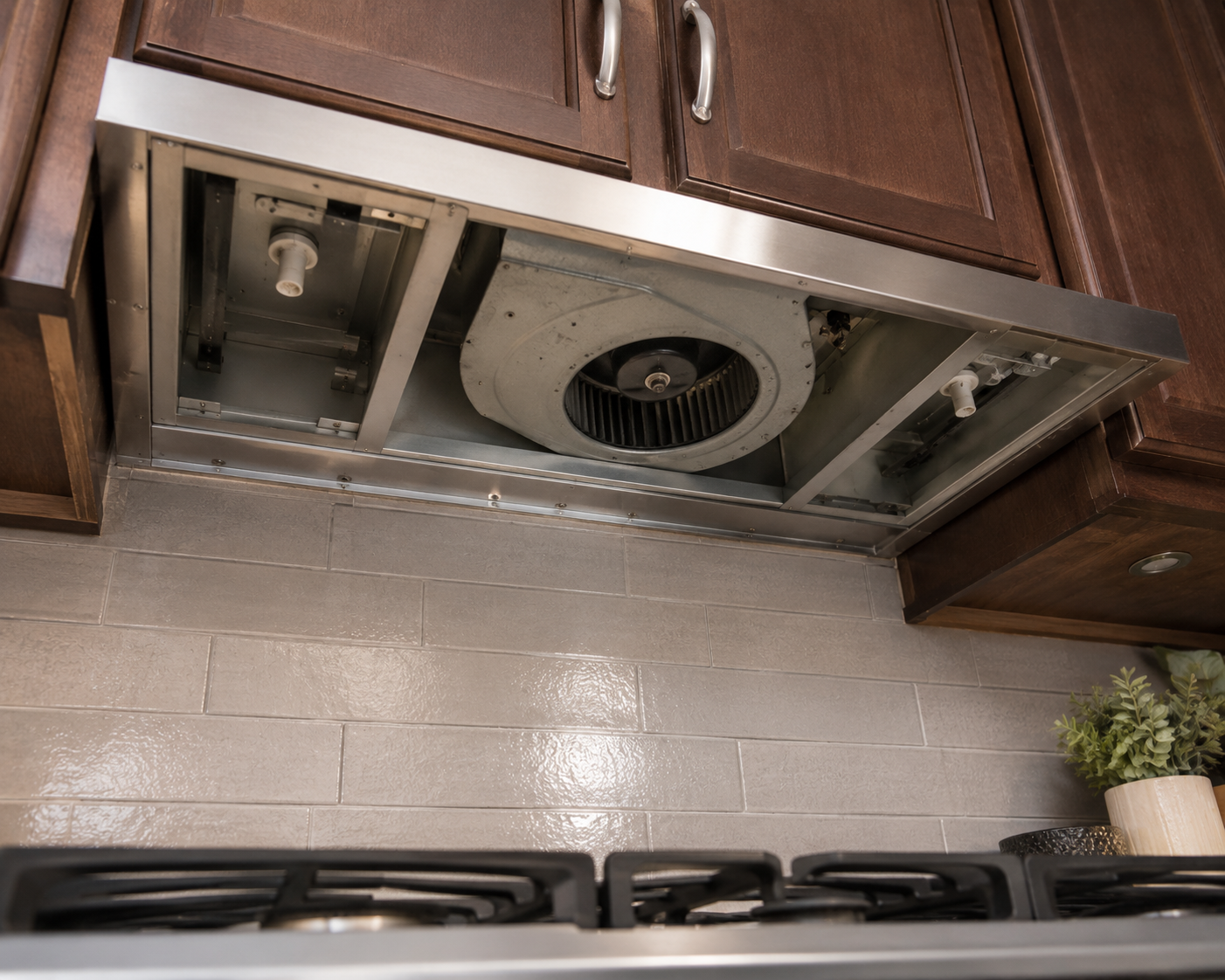 Stainless range hood over a cooktop, viewed from below, a hood diagnosis at a Post Falls home