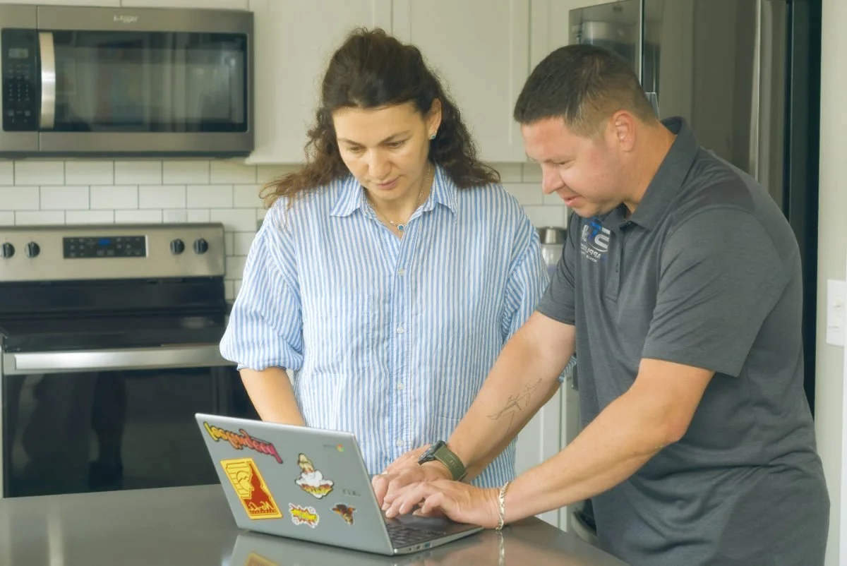 Sergei Dergunov checking an appliance in a Spokane kitchen