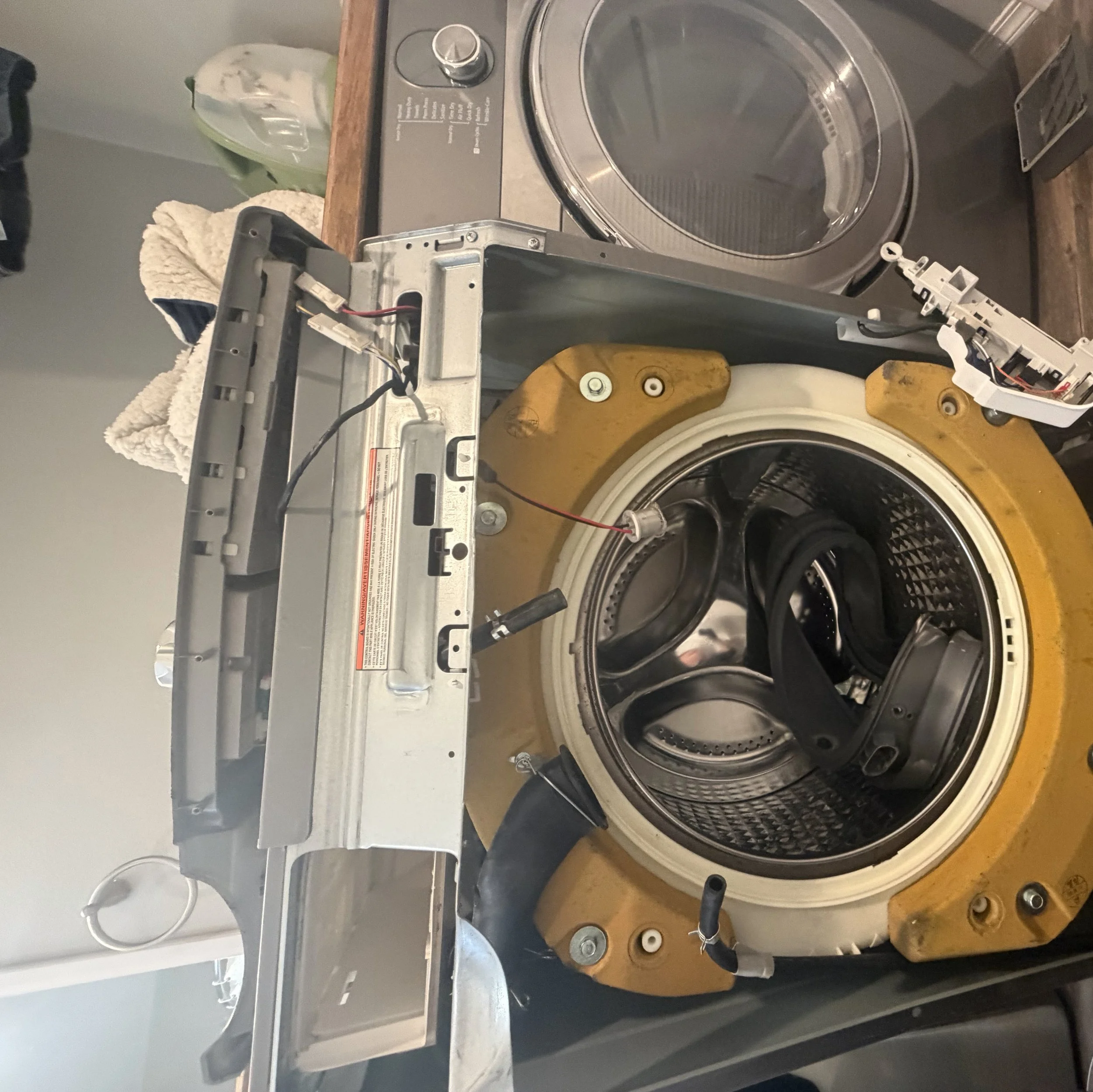 Washer drum with belt and pulley during a Spokane washer repair by SD Appliance