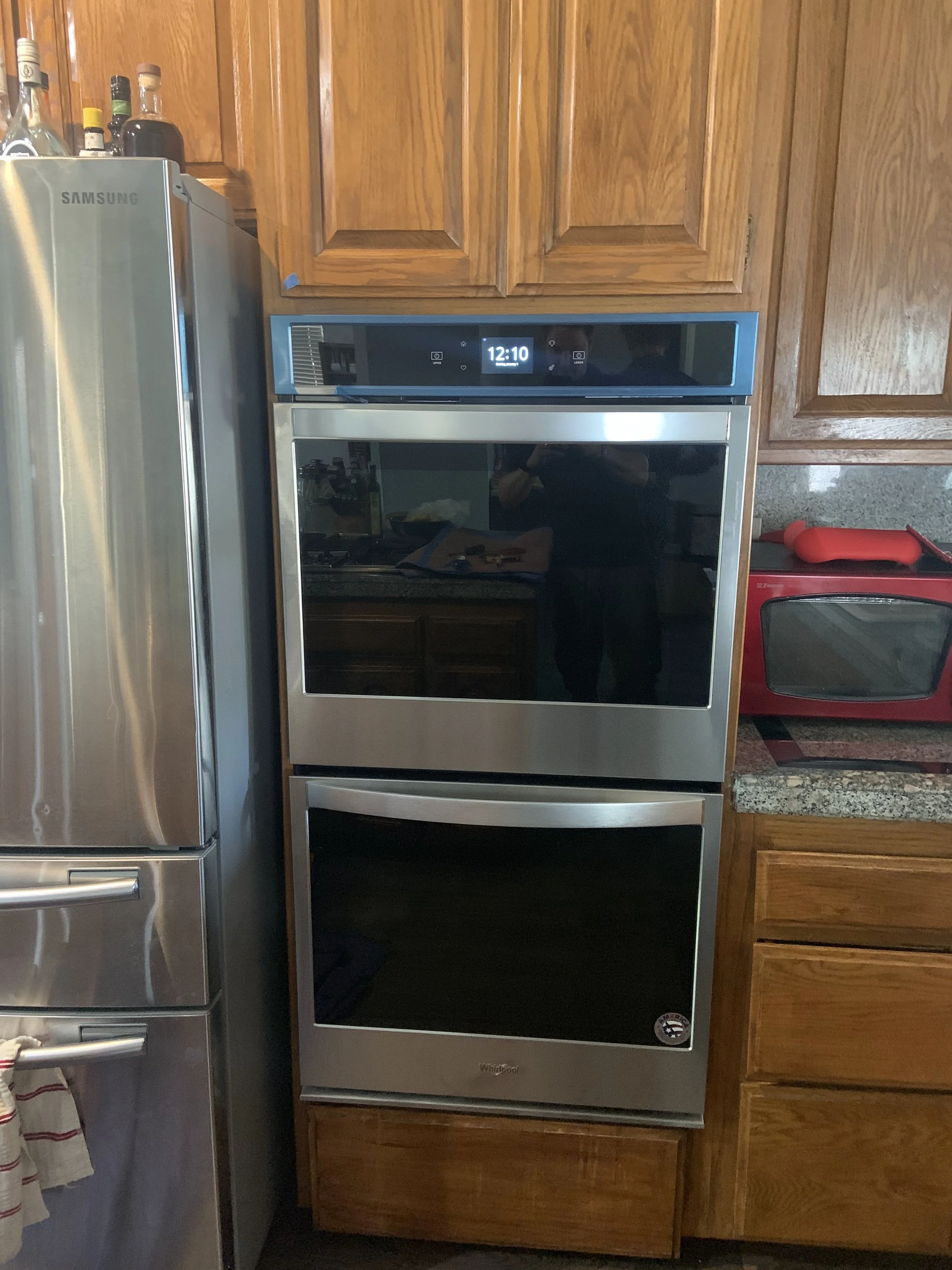Stainless wall oven built into cabinetry, the kind of oven whose serial tag dates it in a Post Falls house