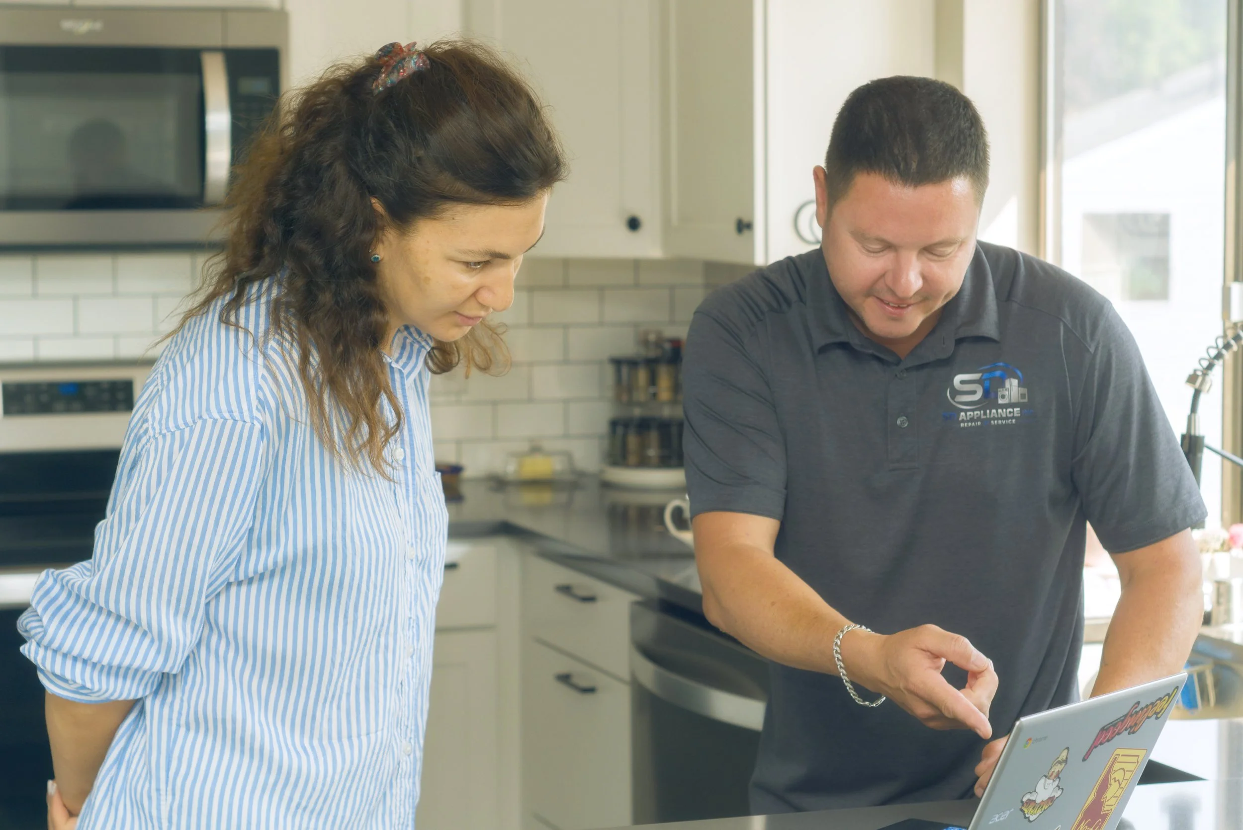 Sergei showing a homeowner the diagnosis, the finding behind a Post Falls freezer repair bill