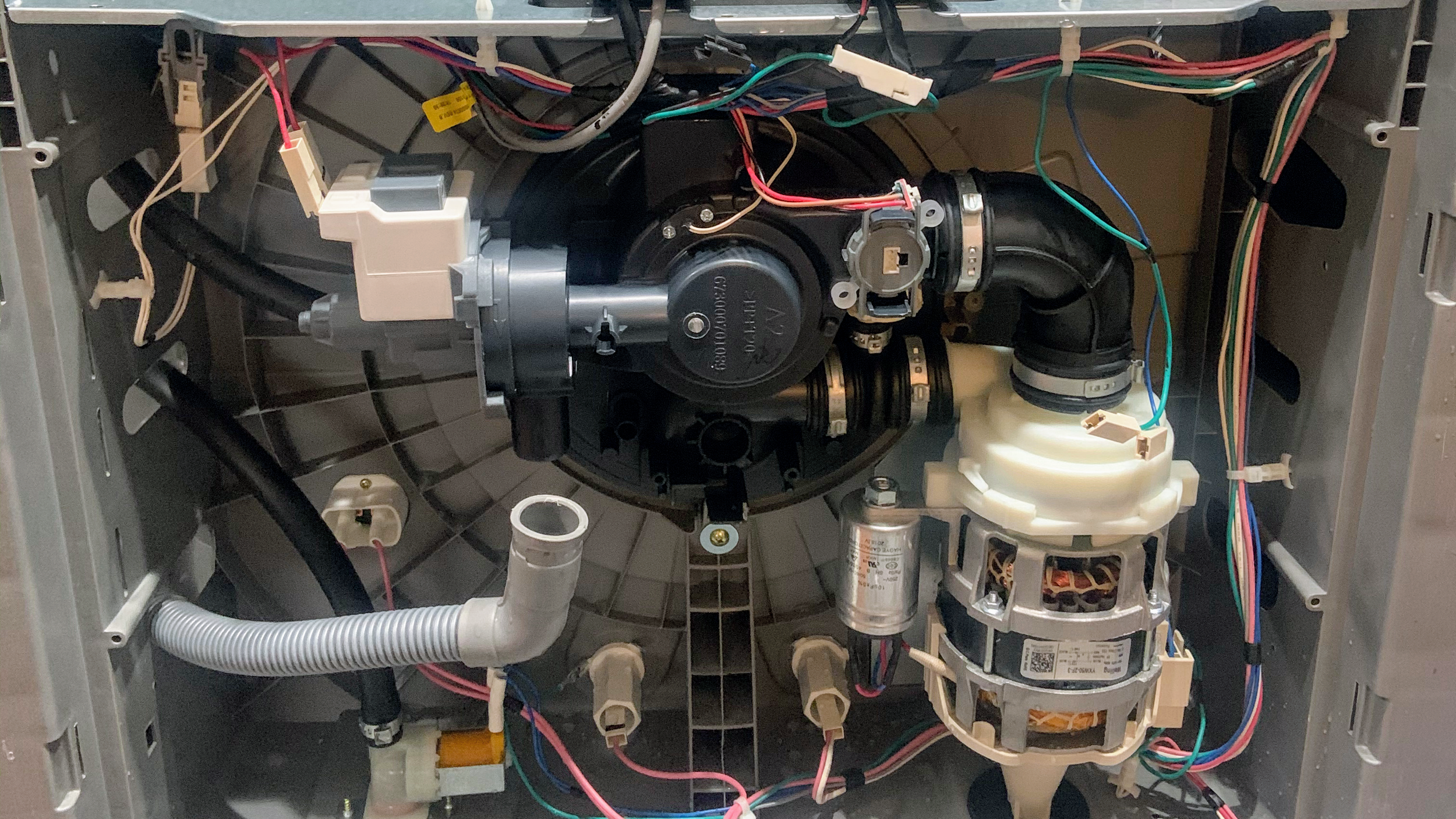 Dishwasher underside: pump and hoses during a Spokane dishwasher repair by SD Appliance