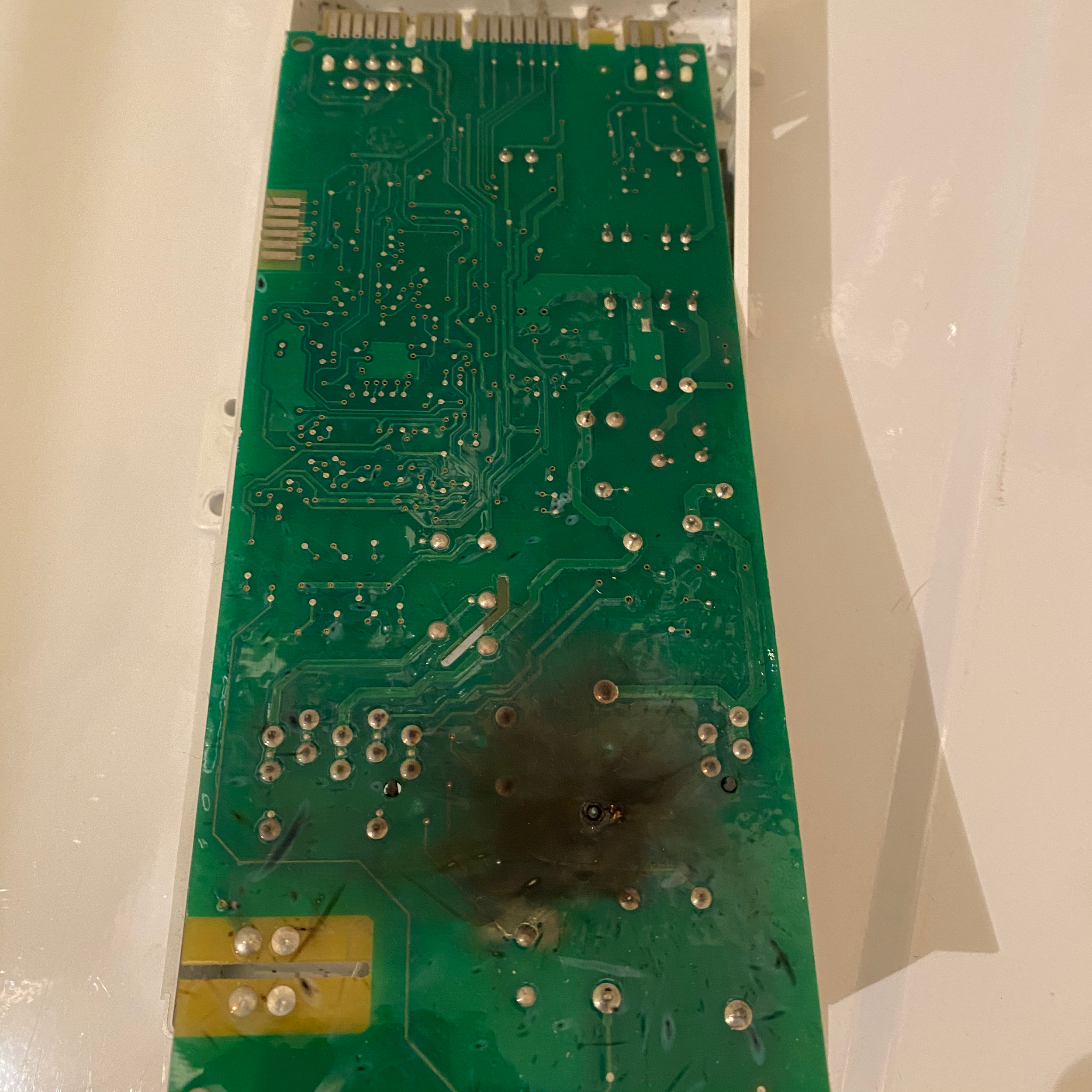 Bare appliance control board on a counter