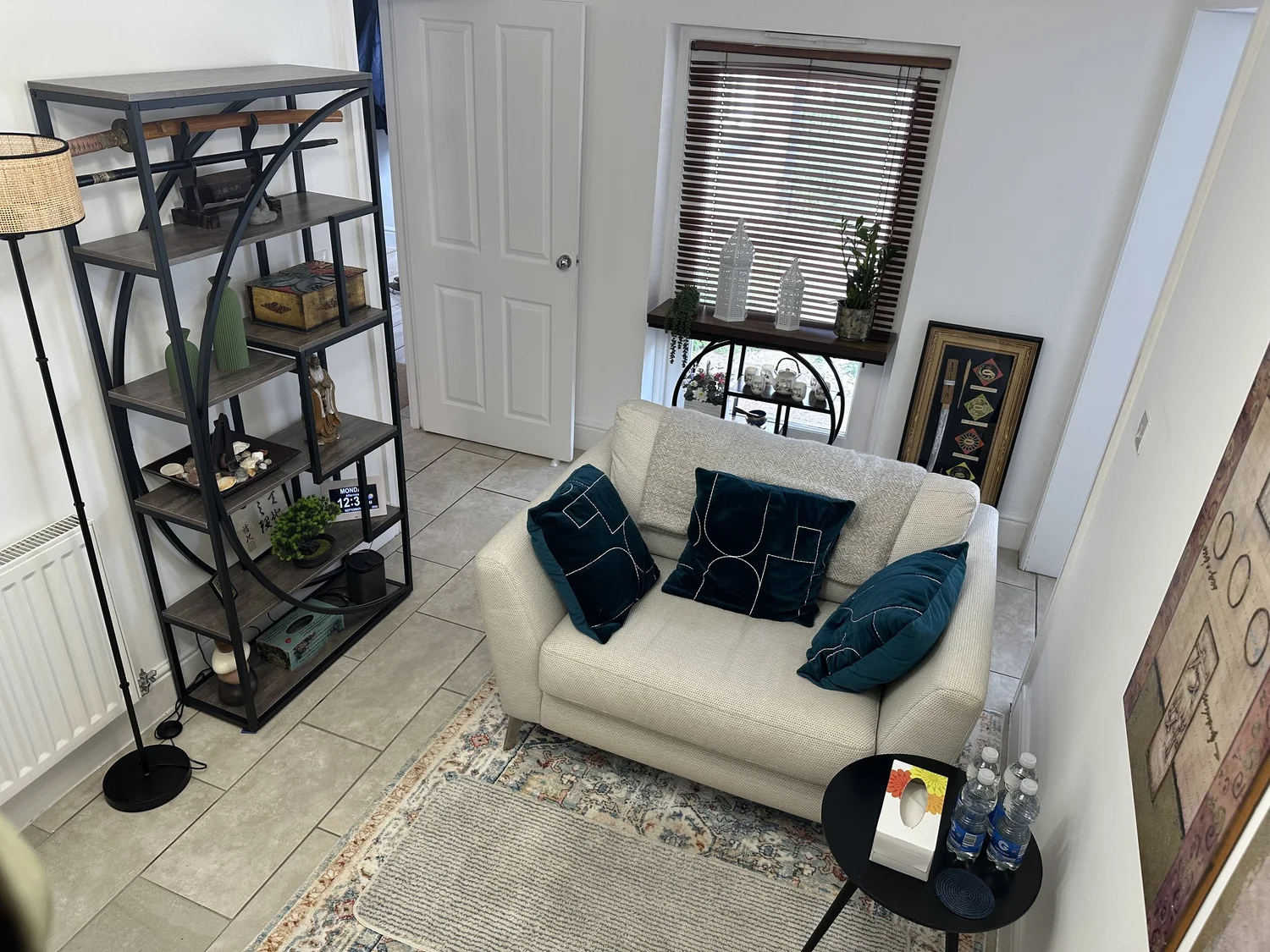 The counselling room in Wolverton: a sofa, an armchair, bookshelves and a window