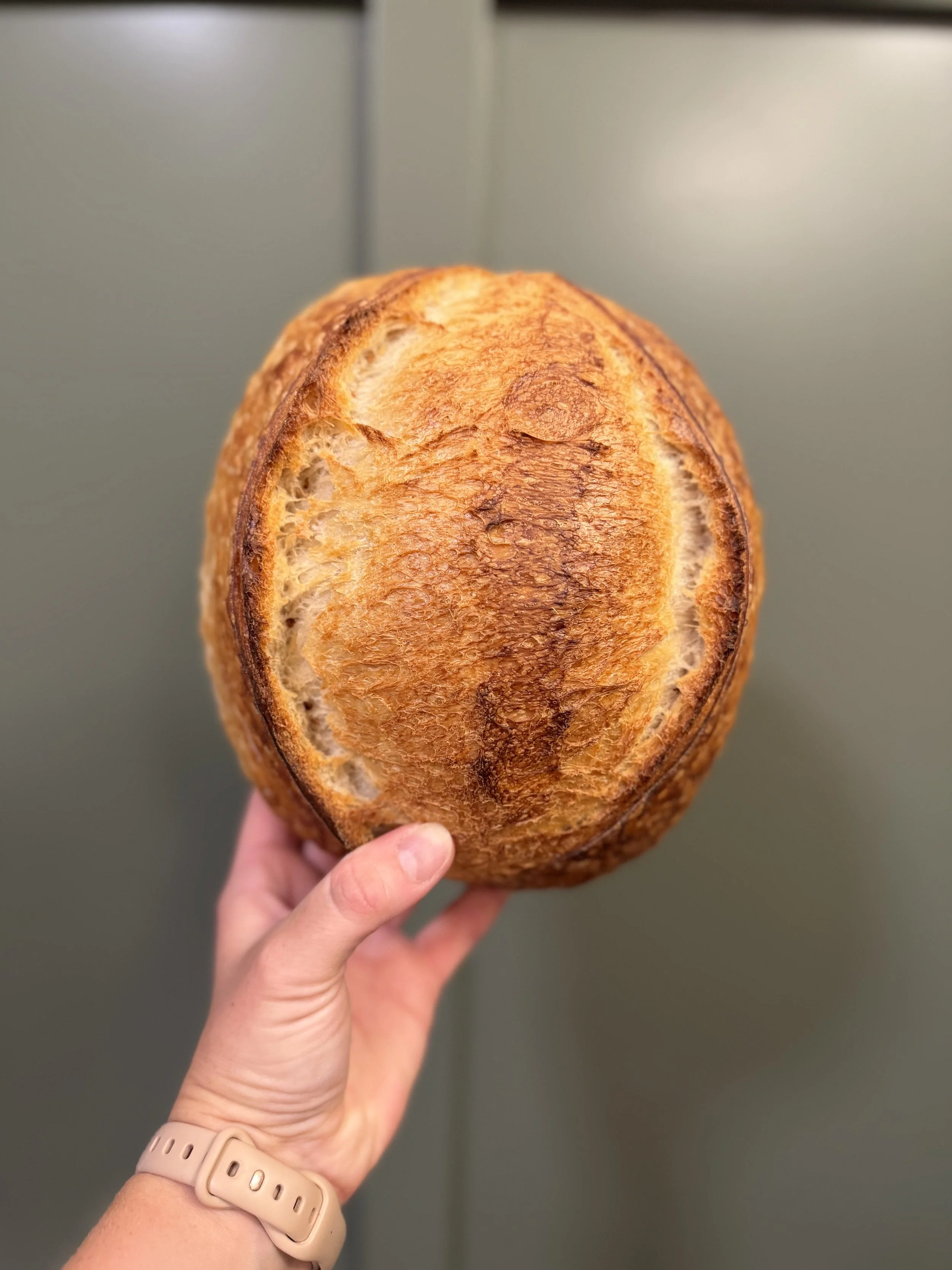 Fresh sourdough bread scoring and baking