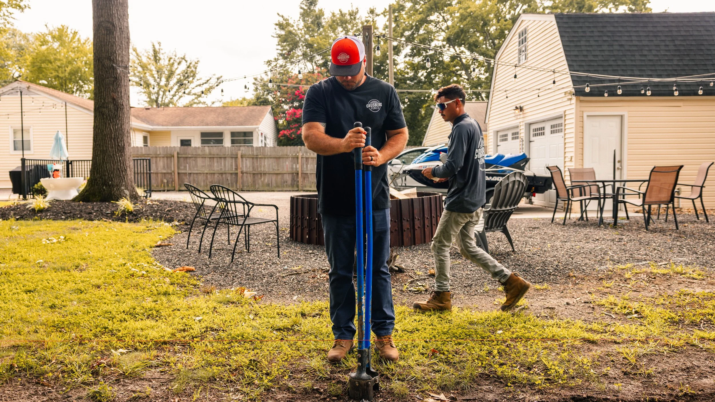 Crusberg Fence crew measuring a fence line for an estimate