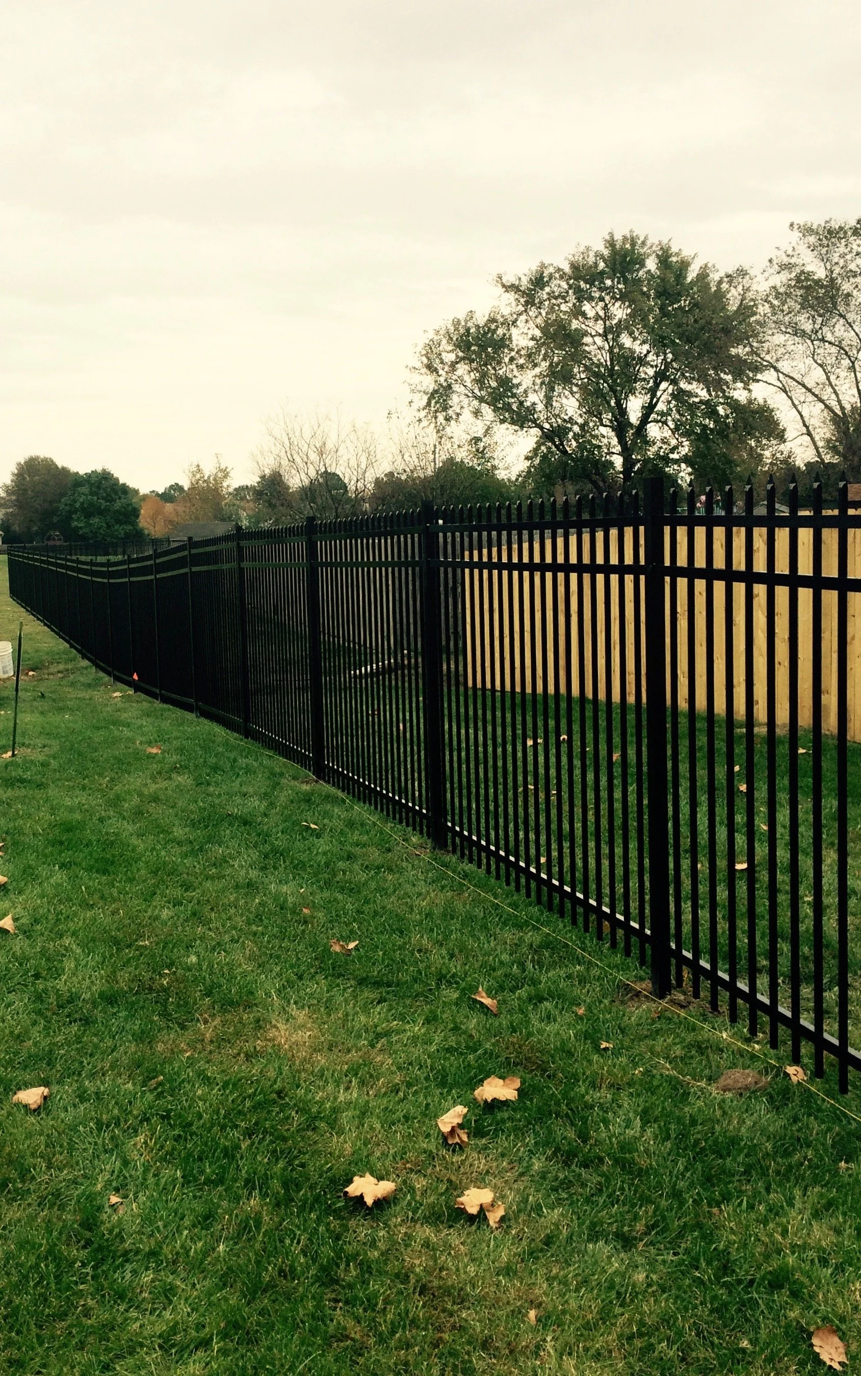 Ornamental aluminum fence line installed by Crusberg Fence