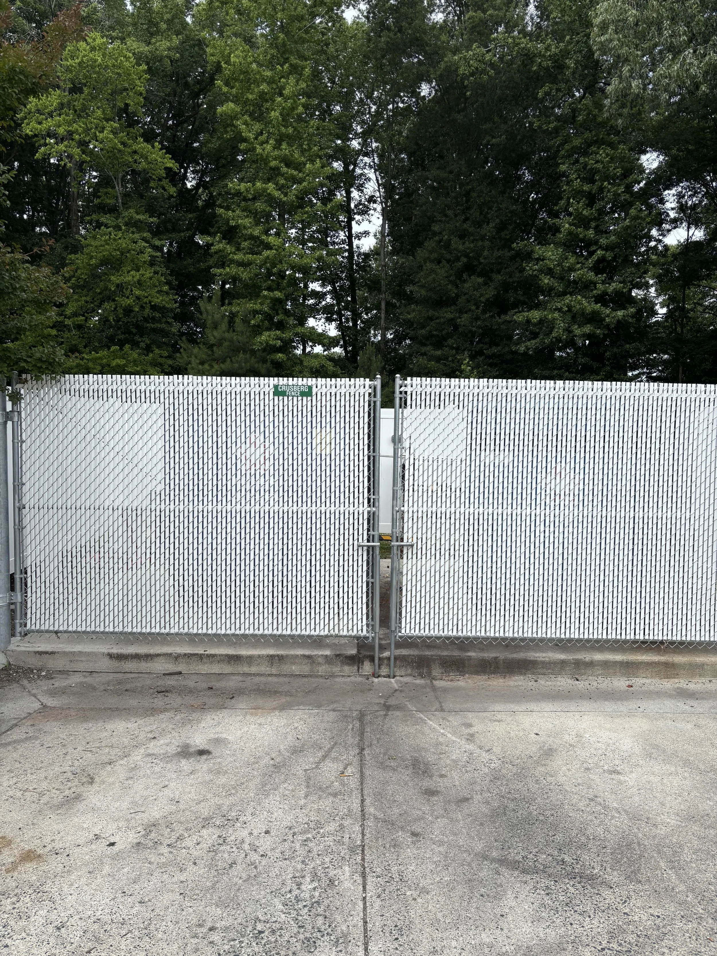 Black vinyl-coated chain link fence by Crusberg Fence