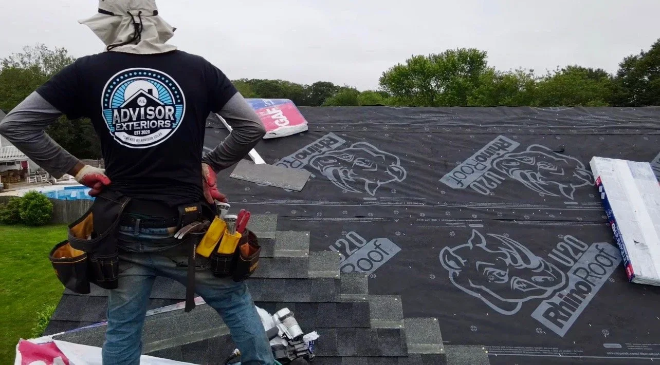Advisor Solar crew member setting out mounting hardware on a shingle roof