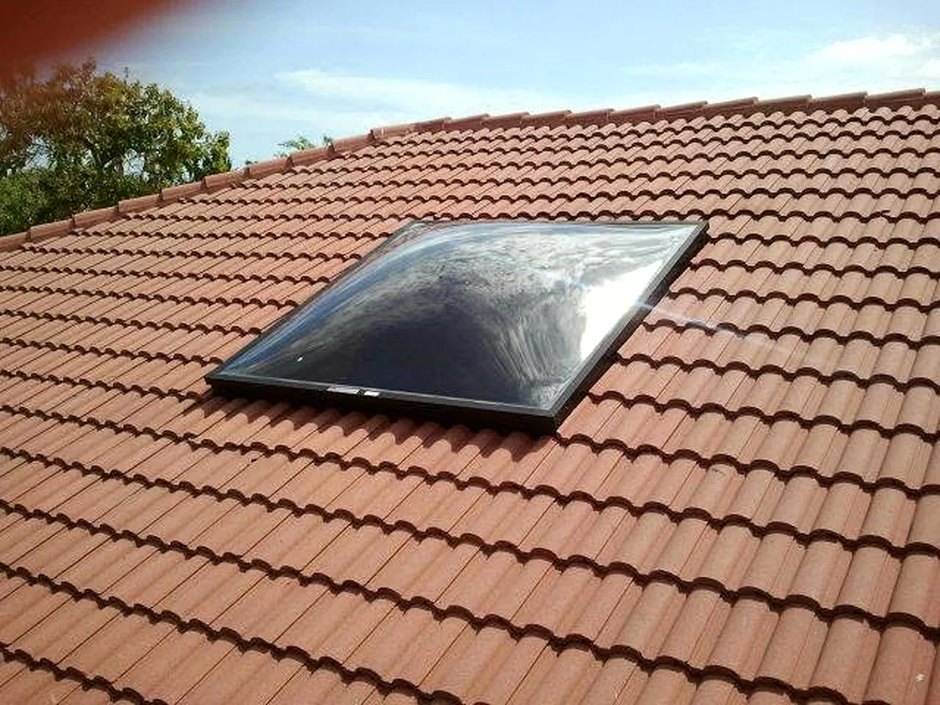 Finished large skylight installed on a South Florida tile roof