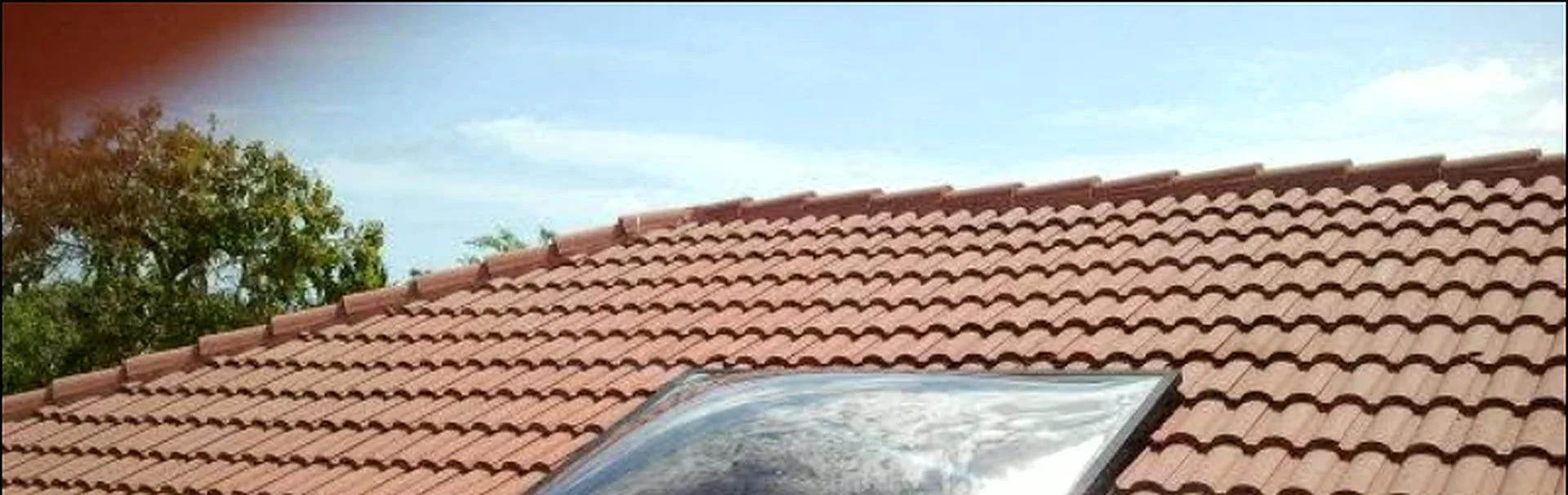 Ambatt Roofing crew repairing skylight area on a tile roof