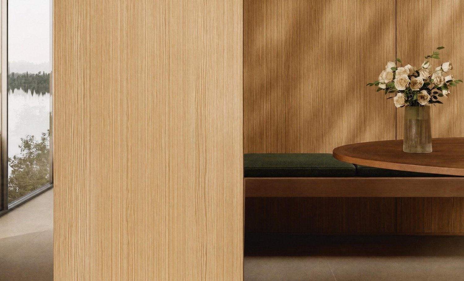 An oak-panelled hall with a dark sculpture, a window onto a lake and garden roses