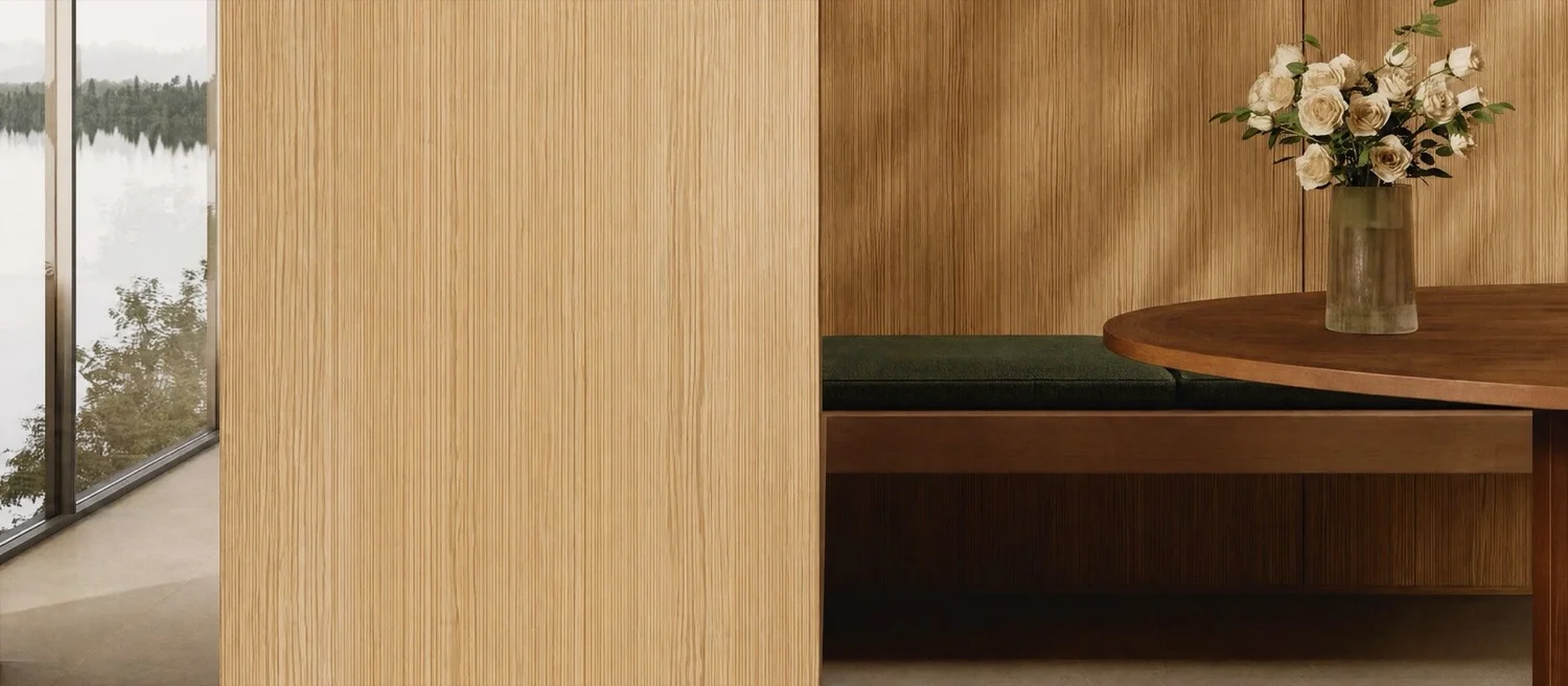 An oak-panelled hall with a dark sculpture, a window onto a lake and garden roses
