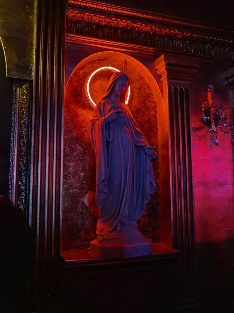 Statue framed by a red neon halo