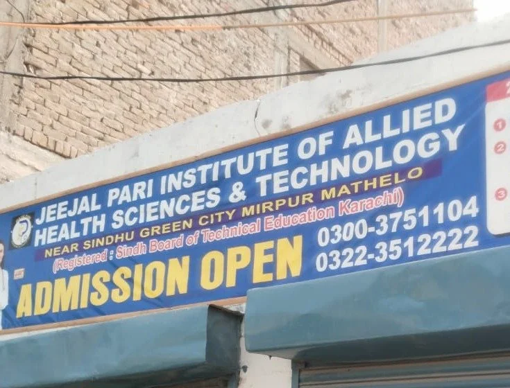 Signboard reading Jeejal Pari Institute of Allied Health Sciences and Technology, Near Sindhu Green City, Mirpur Mathelo, with an admissions-open banner