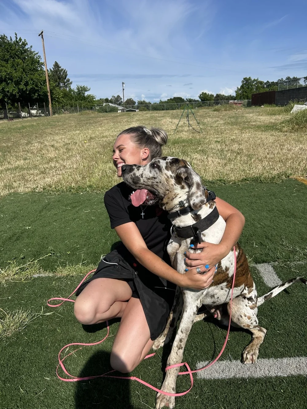 Arkhein trainer sharing a relaxed moment with a Great Dane outdoors
