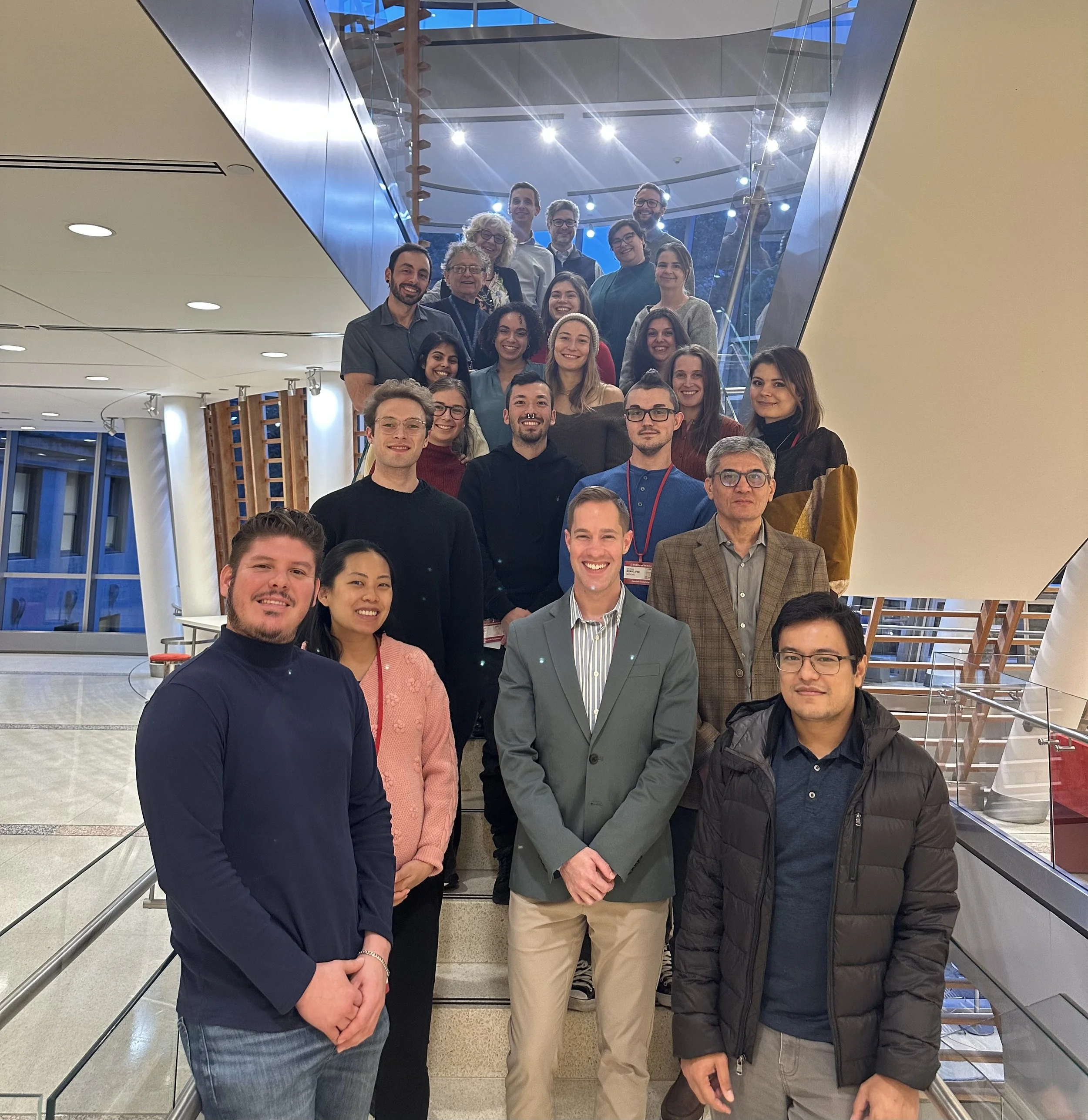 Members of the Nussenzweig and Jones laboratories gathered on a staircase at the INSPIRE kickoff meeting
