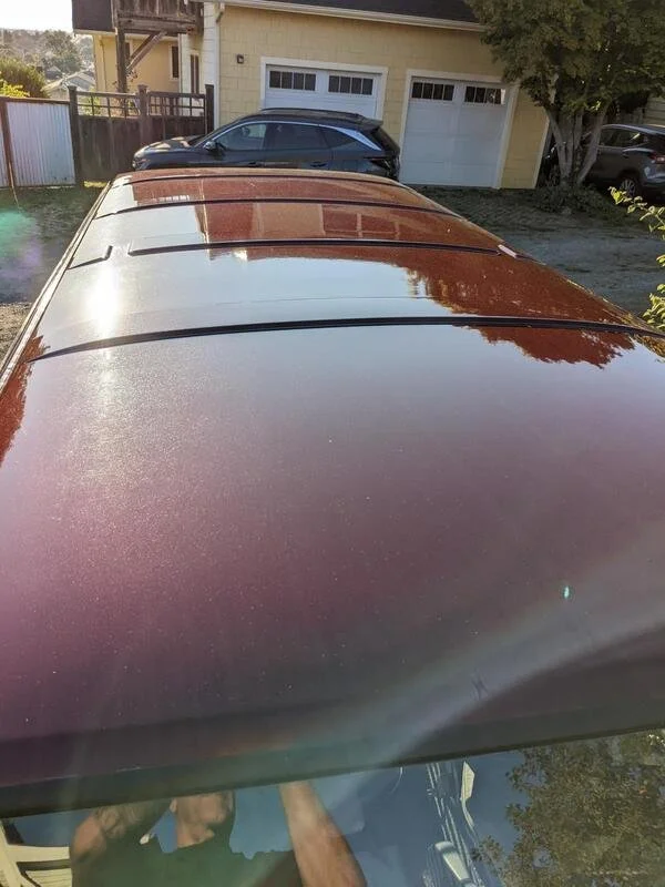 View across the burgundy roof of a Volkswagen van