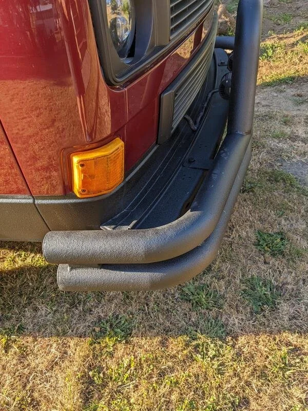 Rear bumper and corner of a burgundy Volkswagen van