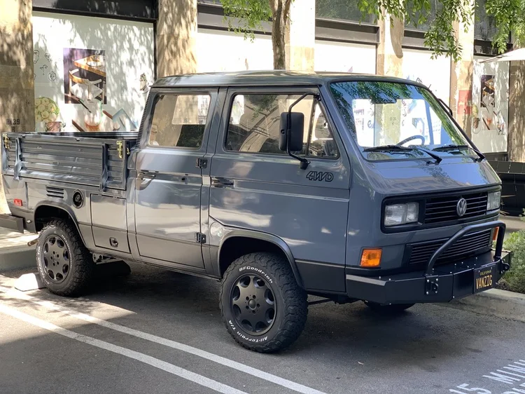 Blue Volkswagen double-cab pickup parked outside