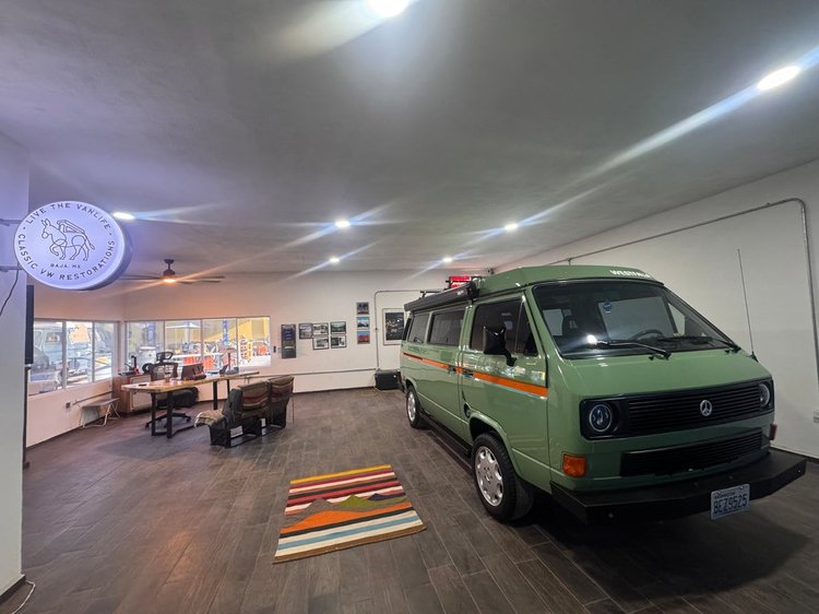 Green Volkswagen Vanagon inside the LiveTheVanLife office and showroom
