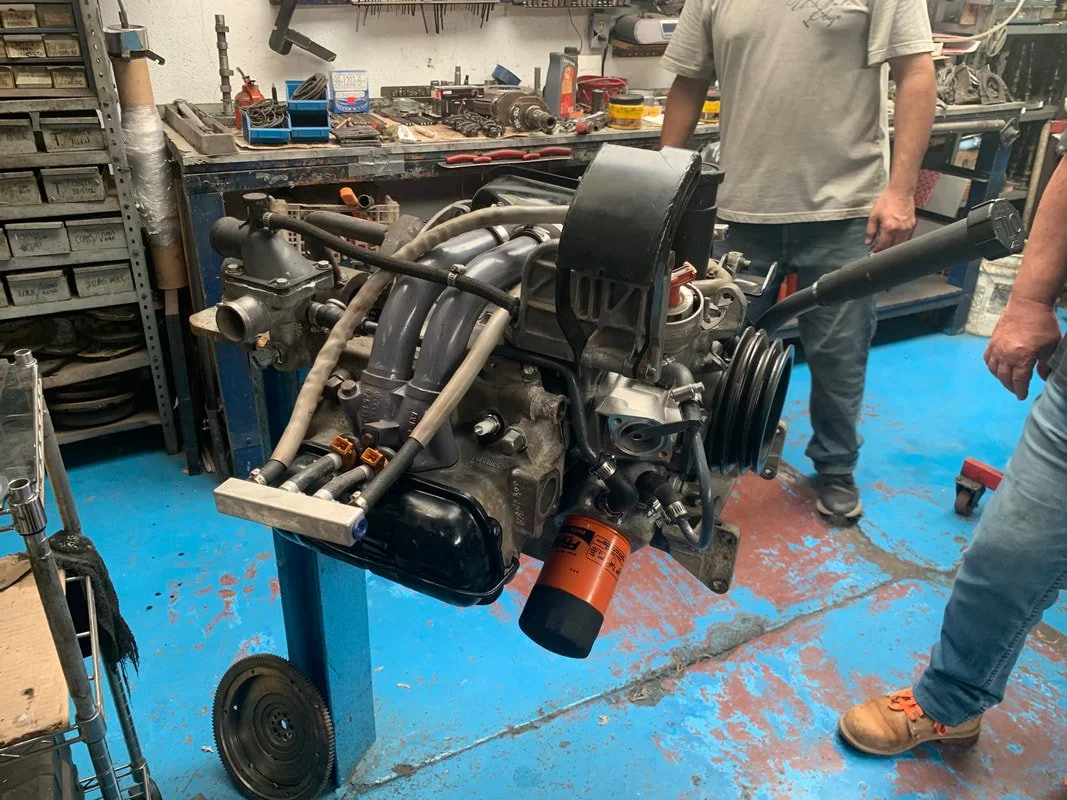 A Volkswagen Waterboxer engine on a stand in the workshop
