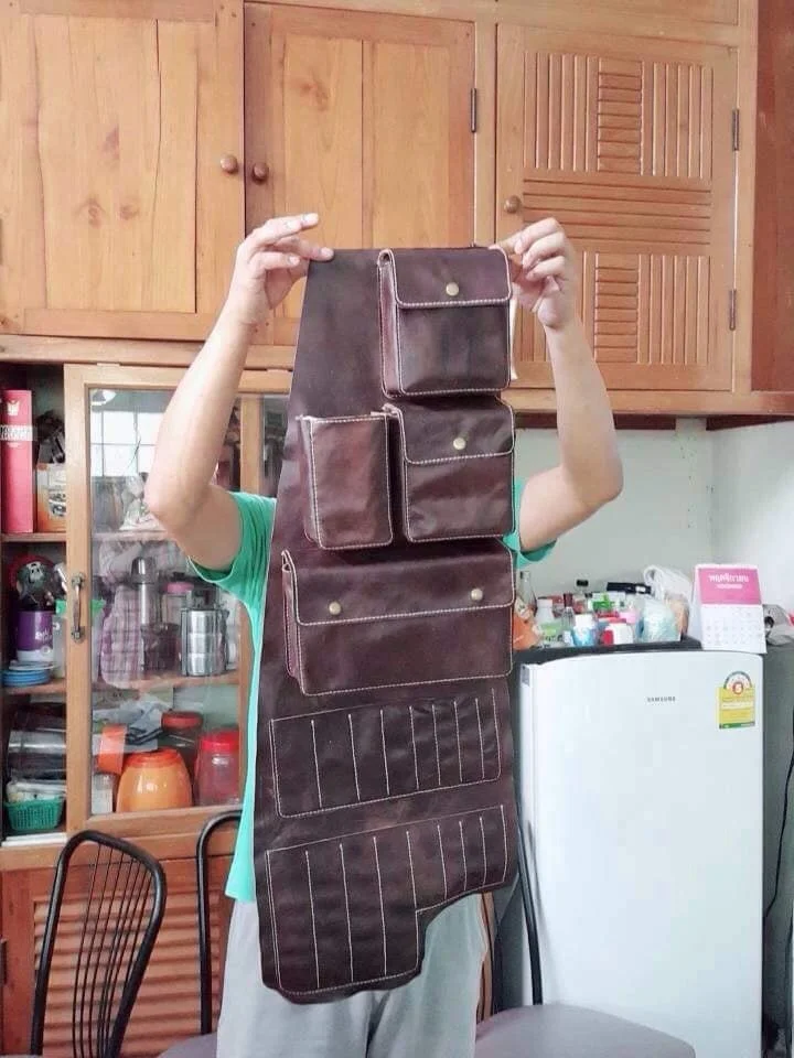 Early leather organizer prototype held up in a kitchen