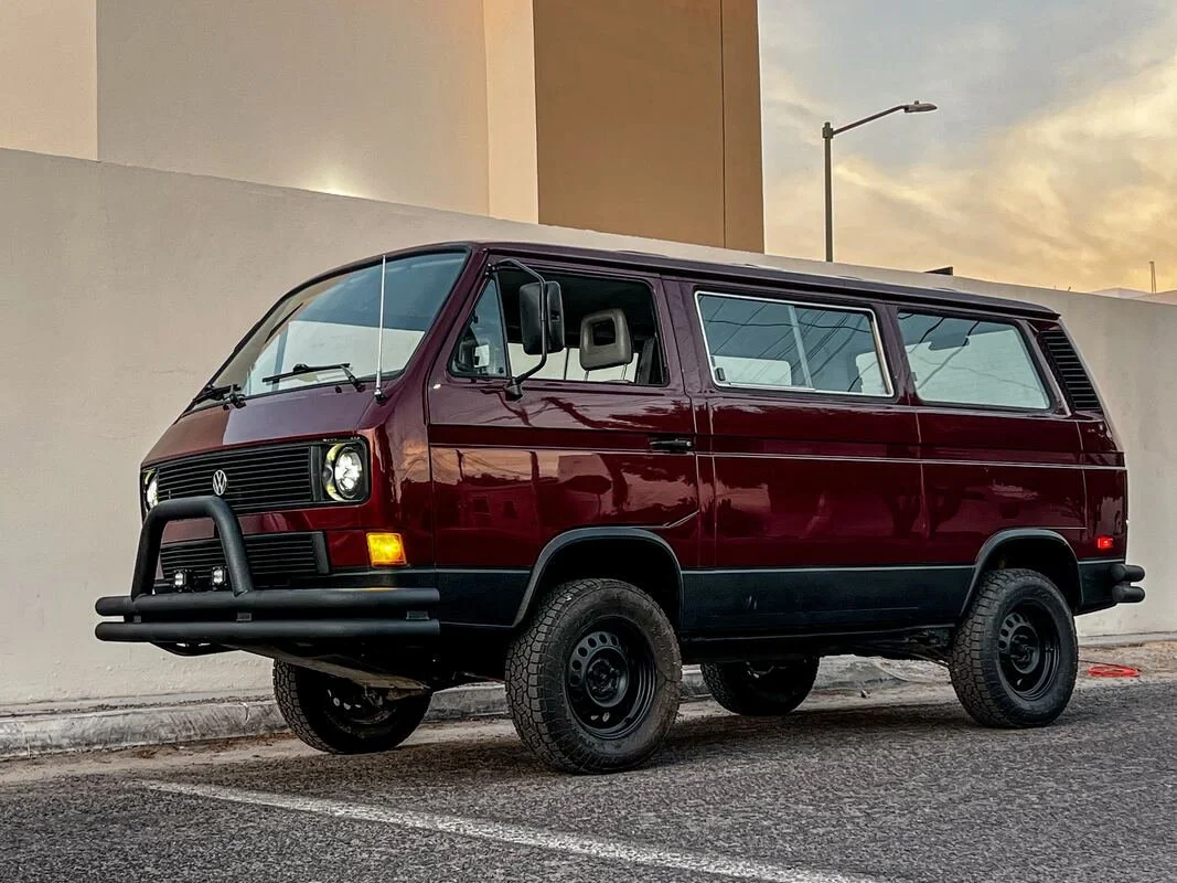 Front three-quarter view of a burgundy Volkswagen Vanagon