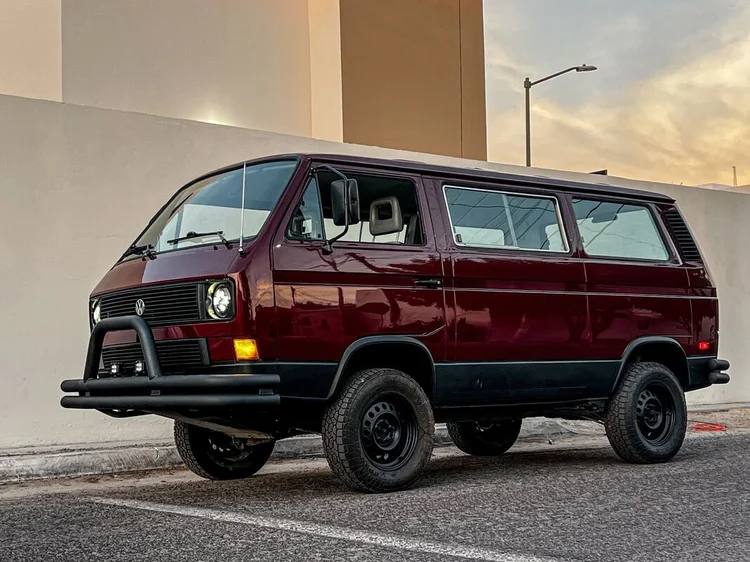 Front three-quarter view of a burgundy Volkswagen Vanagon