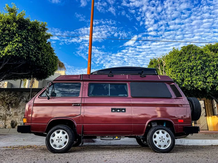 Side view of a burgundy Volkswagen Vanagon