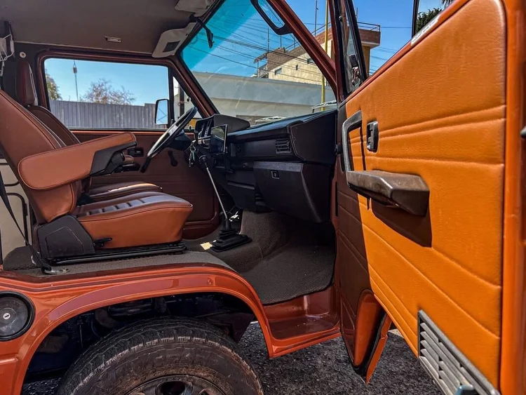 Orange Volkswagen camper cab with brown seats and matching door trim