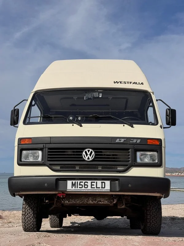 Front view of a cream high-roof Volkswagen camper