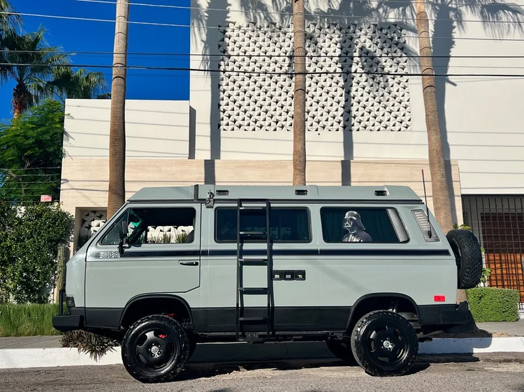 Pale green Volkswagen Vanagon with a side ladder