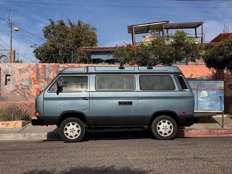 Gray-green Volkswagen Vanagon parked in profile