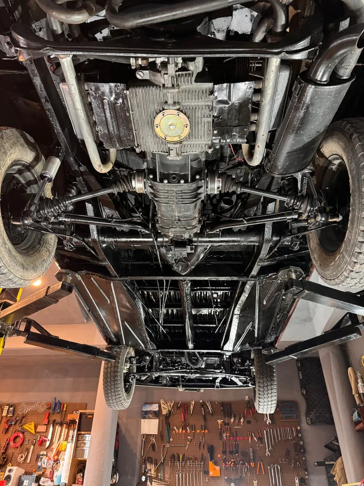 View of a Volkswagen van drivetrain and underside on a lift