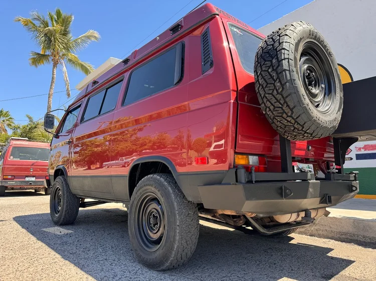 Rear view of a red Volkswagen Vanagon with spare wheel carrier
