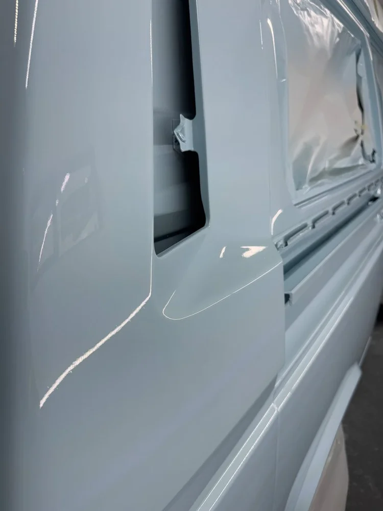 Light blue Volkswagen side panel and masked window opening