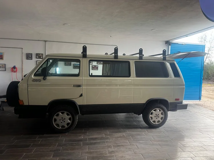 Beige Volkswagen camper in profile inside a building