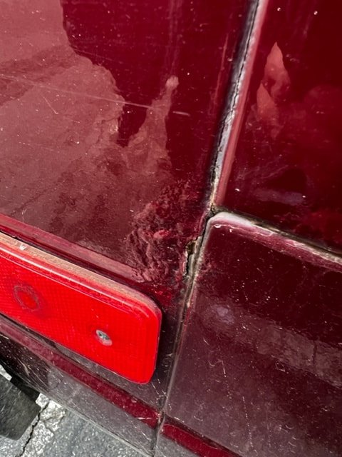 Close-up of paint wear near a Volkswagen rear lamp
