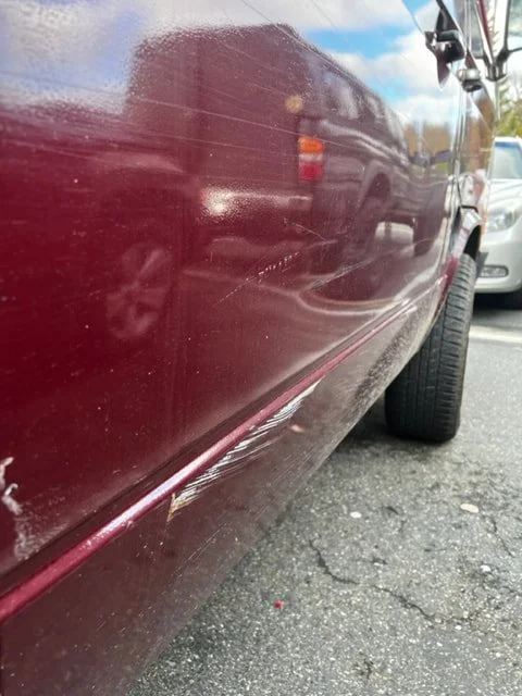 Close-up of a burgundy Volkswagen lower body panel