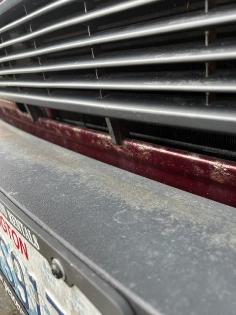 Close-up of a Volkswagen front grille and surrounding paint
