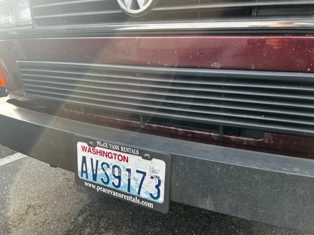 Front grille and bumper of a burgundy Volkswagen Vanagon