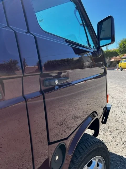 Burgundy Volkswagen front door, mirror and wheel arch