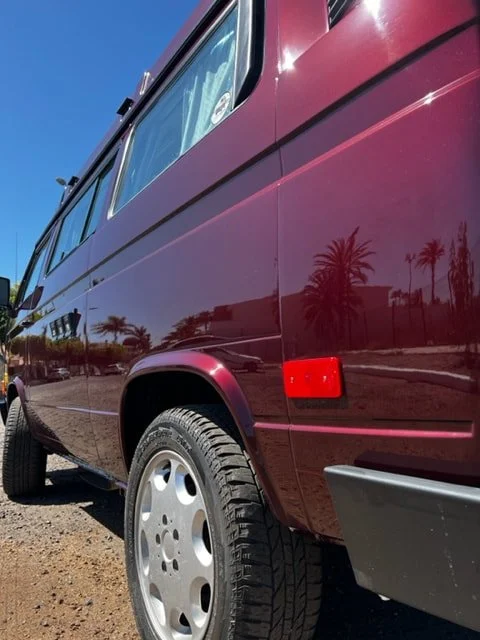 Rear quarter of a burgundy Volkswagen camper
